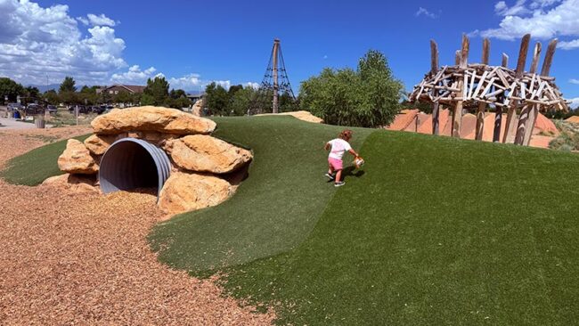 Log tunnel and natural climbing features at McKay Lake nature play
