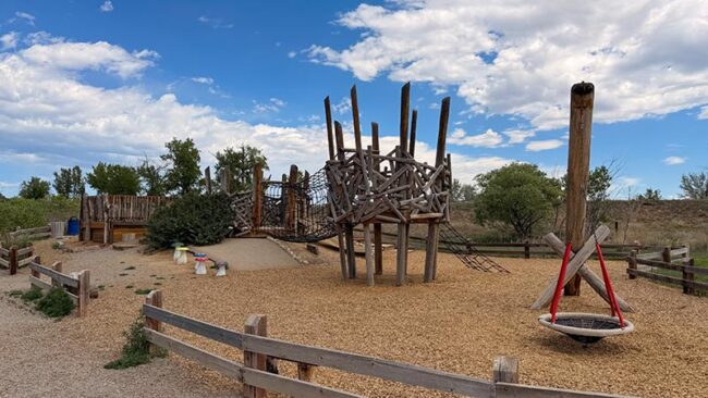 Log tunnel and natural climbing features at McKay Lake nature play area