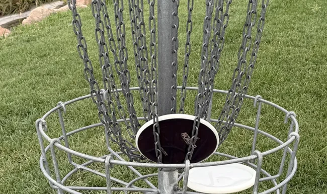 Midway Park North, Broomfield, CO. Disc golf holing out