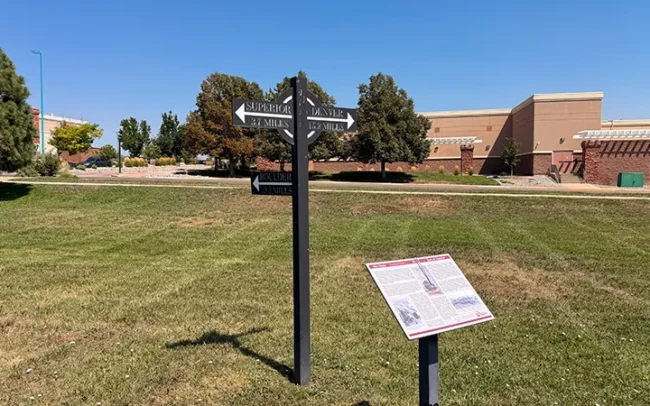 Directional Sign Behind Kite Route History Plaque