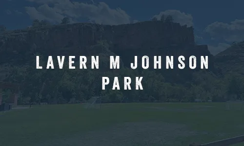 LaVern M. Johnson Park with grassy field and sandstone cliffs in Lyons Colorado