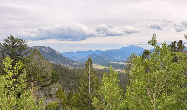 Mountain valley and forested slopes viewed from Rainbow Curve Overlook in Rocky Mountain National Park