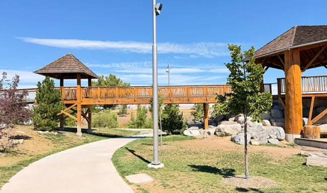 Elevated wooden bridge and play towers at Westminster Station Park Nature Playground