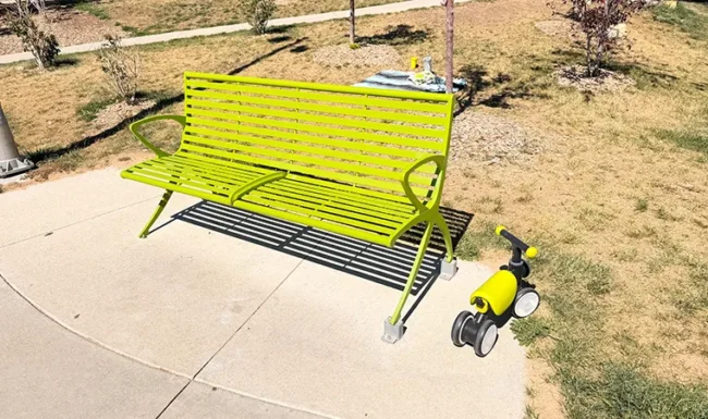 Green park bench and small play feature at Westminster Station Park