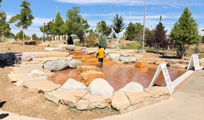 Rock-lined water play area at Westminster Station Park Nature Playground