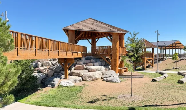 Wooden bridge, timber play structures and climbing boulders at Westminster Station Park