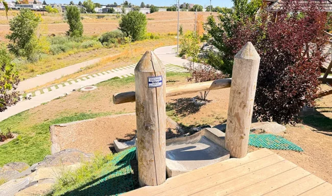 Hillside slide and natural play features at Westminster Station Park Nature Playground