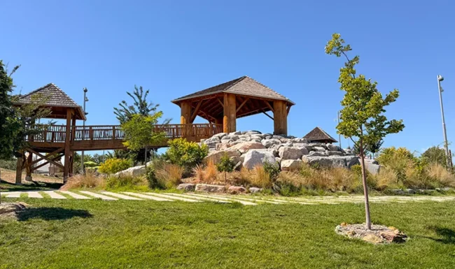 Wooden play structures and boulder climbing area at Westminster Station Park Nature Playground
