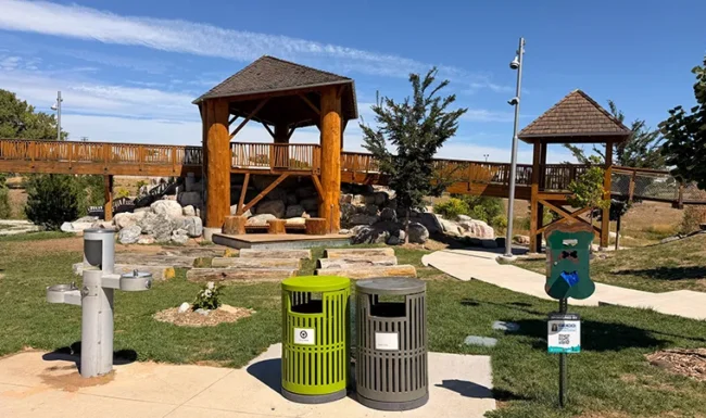 Nature playground with wooden structures, drinking fountain and waste stations at Westminster Station Park