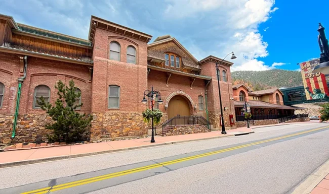 Historic Colorado Central Station red-brick and stone building on a downtown Black Hawk street