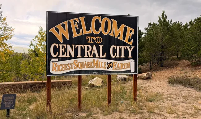 Welcome to Central City sign reading “Richest Square Mile on Earth”