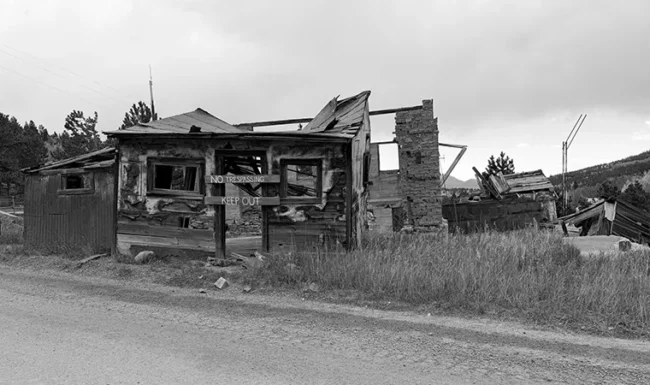 Collapsed historic mining building with No Trespassing sign near Central City, Colorado