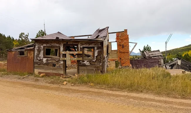 Collapsed historic mining building with No Trespassing sign near Central City, Colorado