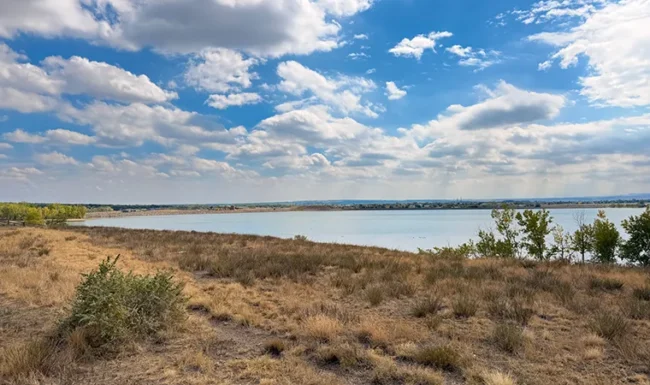 Boulder Reservoir viewed across dry grassland