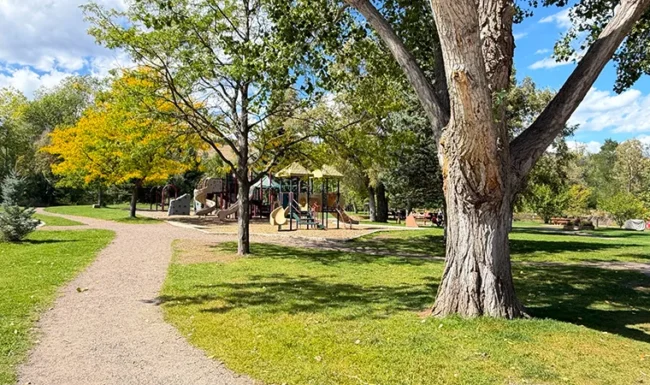 Shaded playground and walking path at Bohn Park in Lyons, Colorado