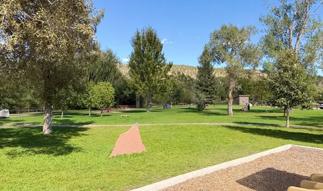 Grassy open space and mature trees at Bohn Park in Lyons, Colorado