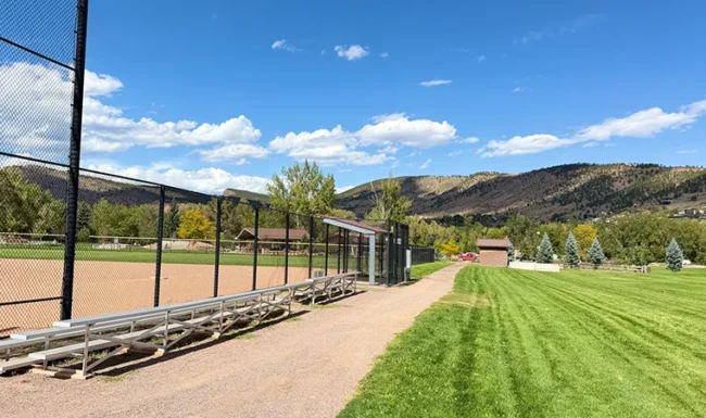 Ball field bleachers and mountain views at Bohn Park in Lyons, Colorado