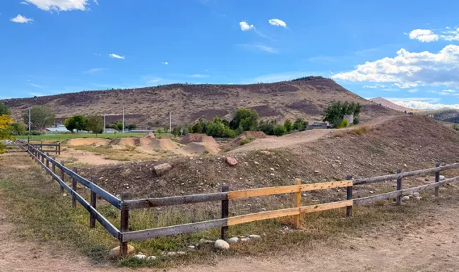 Dirt jump bike features with mountain Range views at Bohn Park in Lyons