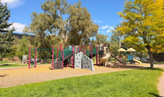 Playground with climbing wall, monkey bars and slides at Bohn Park in Lyons, Colorado