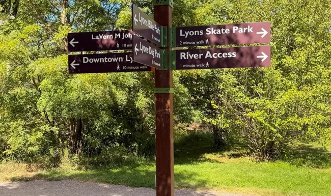 Directional sign for Lyons Skate Park, river access, dog park and downtown Lyons