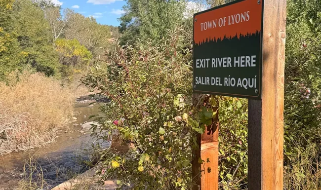 Town of Lyons river exit sign along St. Vrain Creek at Bohn Park