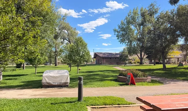 Open lawn and paved path at Bohn Park in Lyons, Colorado