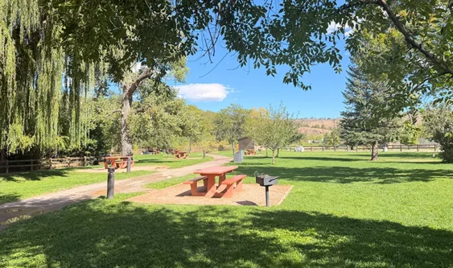 Shaded riverside picnic area at Bohn Park in Lyons, Colorado