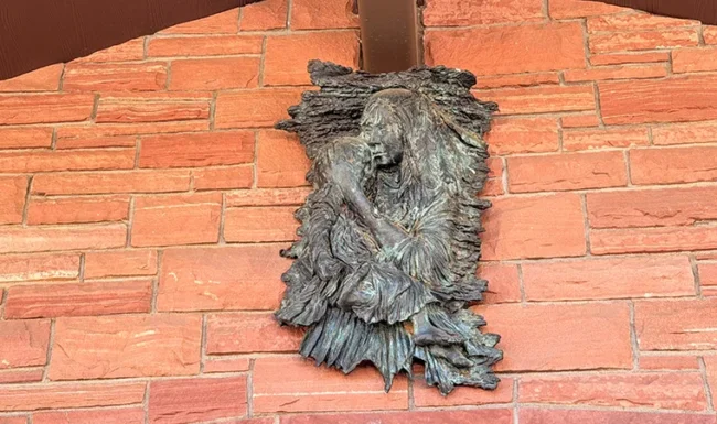 Bronze Native American woman & baby relief artwork on the Bohn Park pavilion in Lyons