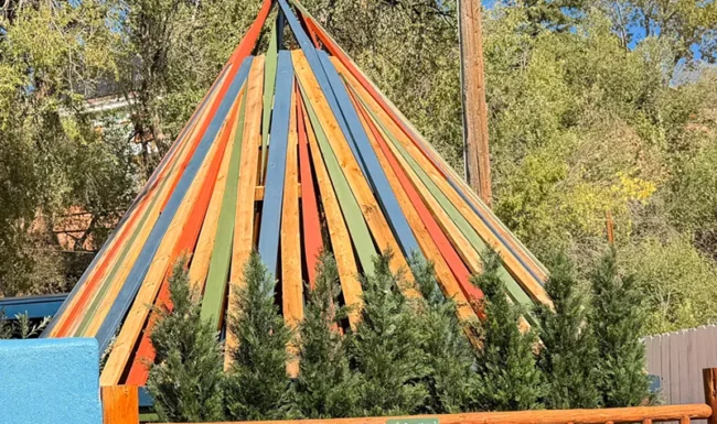 Colorful striped tee pee public art structure in downtown Lyons, Colorado