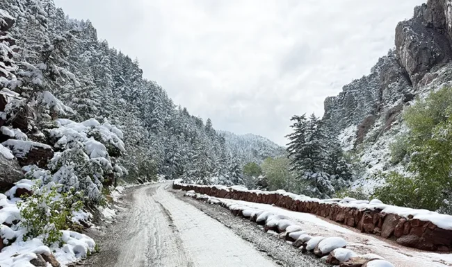 Snow-covered canyon road and sandstone cliffs in Eldorado Canyon