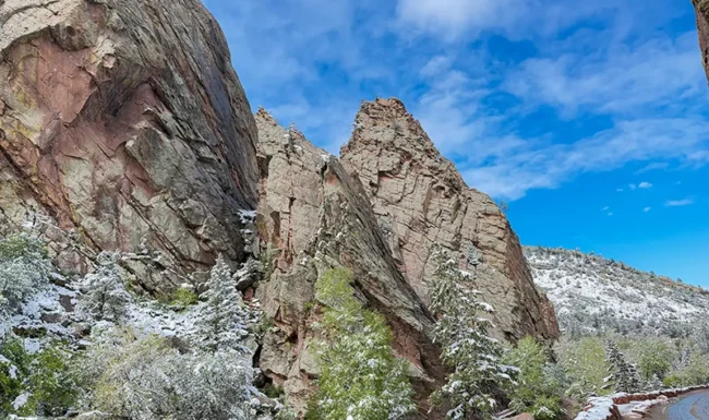 Snowy Eldorado Canyon rock formations beneath a bright blue sky
