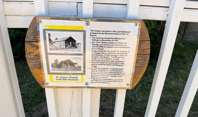 Historical plaque with old photographs describing St. James Chapel, now the Gold Hill Museum.