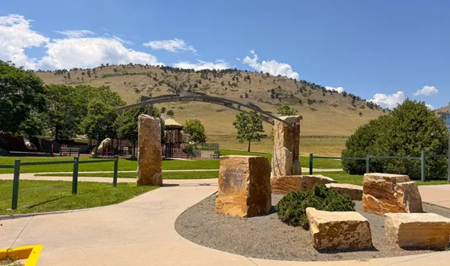 Stone entrance feature and playground at Foothills Community Park in Boulder Colorado