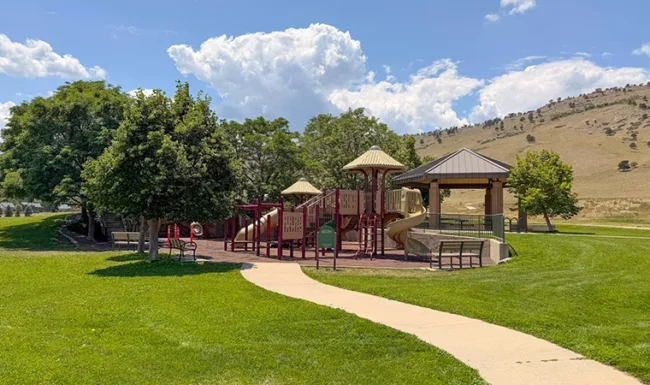 Playground with slides and picnic shelter at Foothills Community Park in Boulder Colorado