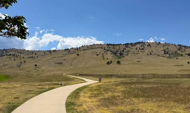 Paved walking path through open space at Foothills Community Park in Boulder Colorad