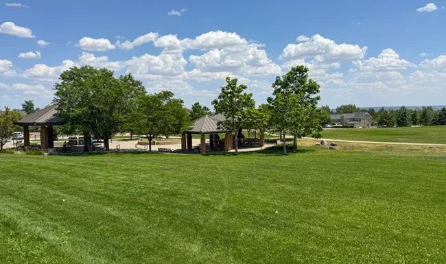 Open lawn and picnic shelters at Foothills Community Park in Boulder Colorado