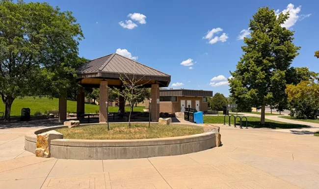 Picnic shelter, benches and restroom building at Foothills Community Park in Boulder Colorado