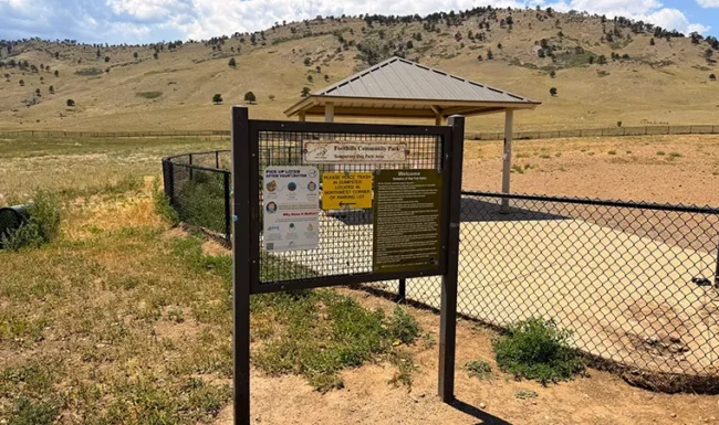 Entrance sign and fenced dog park at Foothills Community Park in Boulder Colorado