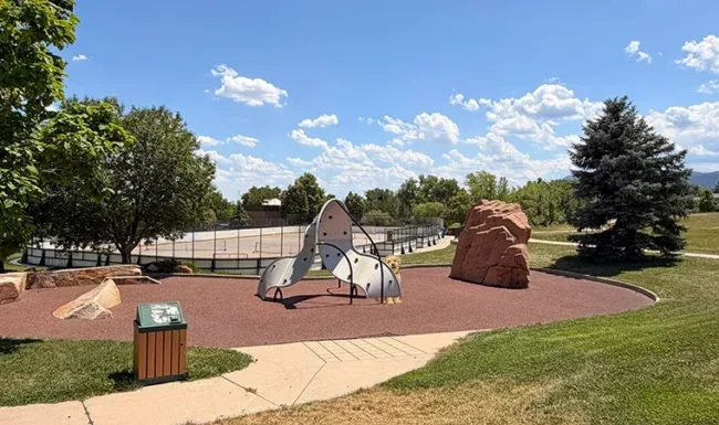 Nature play climbing structures and boulder feature at Foothills Community Park in Boulder Colorado