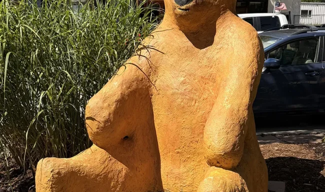 Large orange bear sculpture in downtown Lyons Colorado