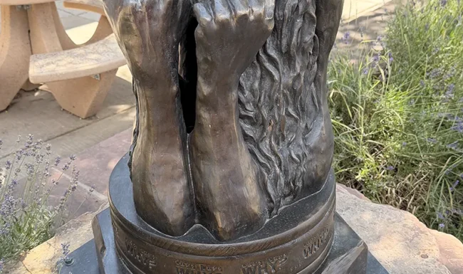 Bronze expressive face sculpture in downtown Lyons Colorado