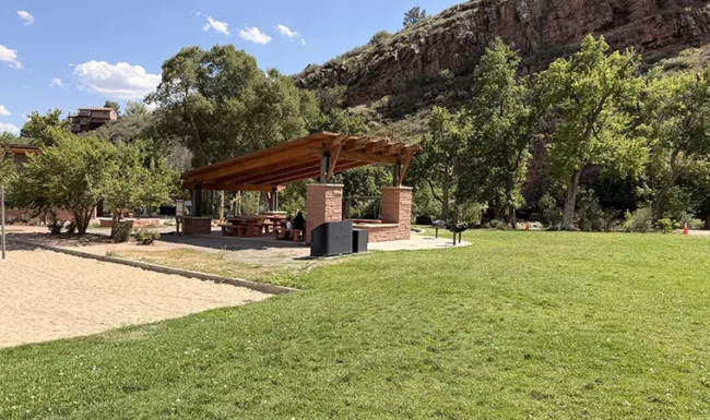 Picnic shelter, sand volleyball court and sandstone cliffs at LaVern M. Johnson Park