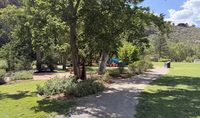 Shaded walking path and landscaped open space at LaVern M. Johnson Park in Lyons