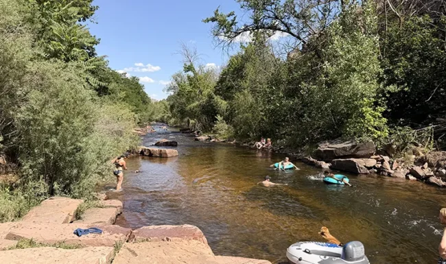 Visitors tubing and wading in North St. Vrain Creek at LaVern M. Johnson Park