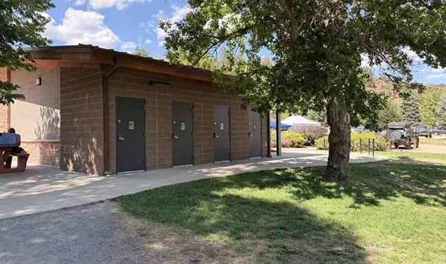 Flush restroom building and shaded lawn at LaVern M. Johnson Park