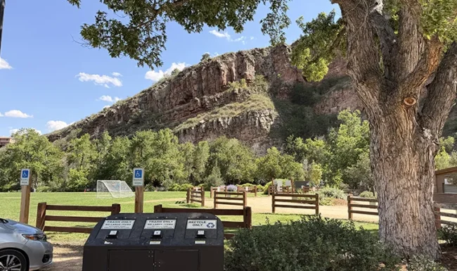 Grassy open space and dramatic sandstone cliffs at LaVern M. Johnson Park in Lyons